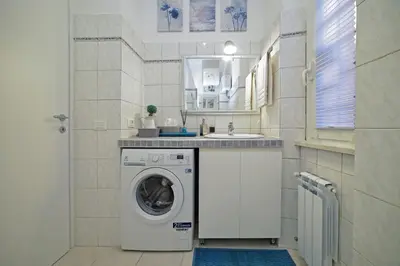 a laundry room with a washing machine and a sink at Lucia Casa Vacanze Ponte Milvio in Rome