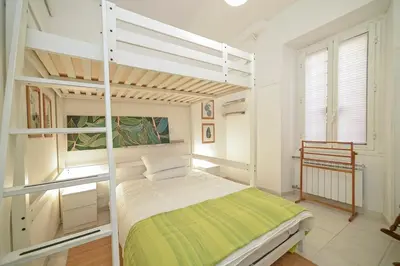 a white bedroom with a bunk bed in a room at Lucia Casa Vacanze Ponte Milvio in Rome