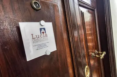 a sign on a door with a sign on it at Lucia Casa Vacanze Ponte Milvio in Rome