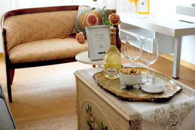 a table with two glasses and a bottle of wine at RHOME - Luxury Sharing Home in Rome