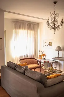 a living room with a couch and a chandelier at RHOME - Luxury Sharing Home in Rome