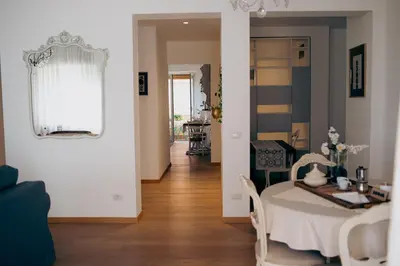 a living room with a table and a dining room at RHOME - Luxury Sharing Home in Rome