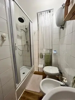 a bathroom with a shower and a toilet and a sink at VerdePigna Apartment in Rome