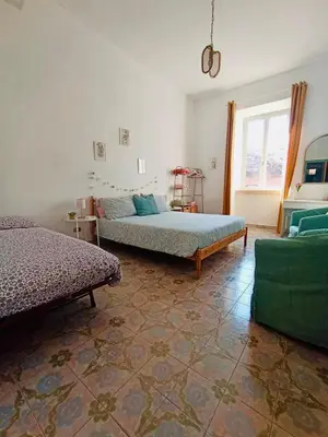 a bedroom with two beds and a window at VerdePigna Apartment in Rome