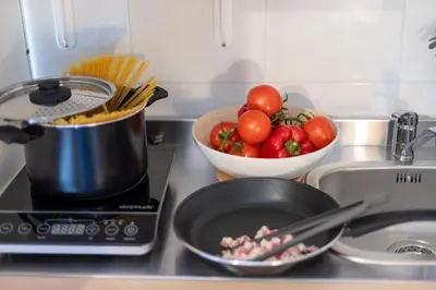 a kitchen counter with a bowl of tomatoes and a pan at Dafne Rooms a relaxing piece of paradise in Rome