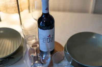a bottle of wine sitting on top of a table at Dafne Rooms a relaxing piece of paradise in Rome