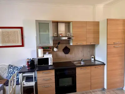 a kitchen with a sink and a microwave at Terracehome71 - Apartment with relaxing terrace near Vatican in Rome