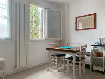 a kitchen with a table and chairs and a window at Terracehome71 - Apartment with relaxing terrace near Vatican in Rome