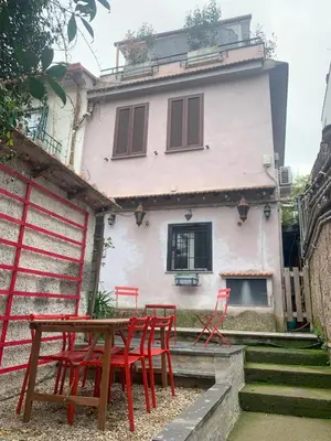 a table and chairs in front of a house at Terracehome71 - Apartment with relaxing terrace near Vatican in Rome