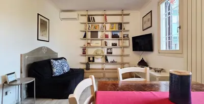 a living room with a table and a chair at Terracehome71 - Apartment with relaxing terrace near Vatican in Rome