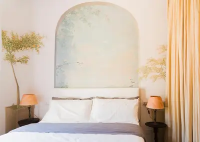 a bedroom with a bed with an arch above it at Villa Mara Appia antica in Rome