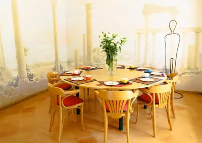 a dining room with a table and chairs at Villa Mara Appia antica in Rome