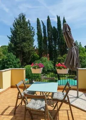 a patio with a table and chairs and a umbrella at Villa Mara Appia antica in Rome