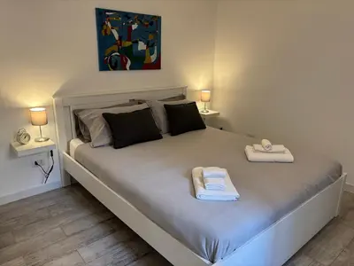 a bedroom with a bed with two towels on it at Monteverde Nest in Rome