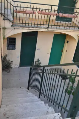 a staircase leading to a building with green doors at Monteverde Nest in Rome