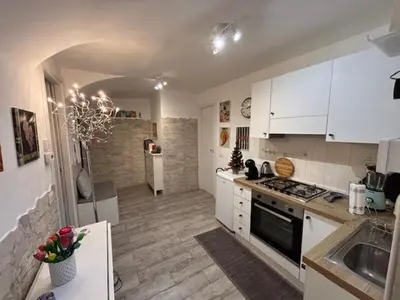 a kitchen with white cabinets and a stove top oven at Monteverde Nest in Rome