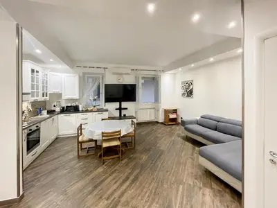 a kitchen and living room with a table and a couch at roominrome Alexander Apartment in Rome