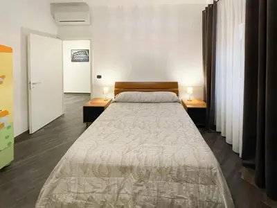 a bedroom with a large bed with two night stands at roominrome Alexander Apartment in Rome