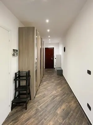 a hallway with a chair and a door in a room at roominrome Alexander Apartment in Rome