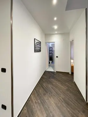 an empty room with white walls and wood floors at roominrome Alexander Apartment in Rome