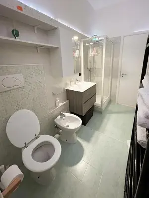 a bathroom with a toilet and a sink at roominrome Alexander Apartment in Rome