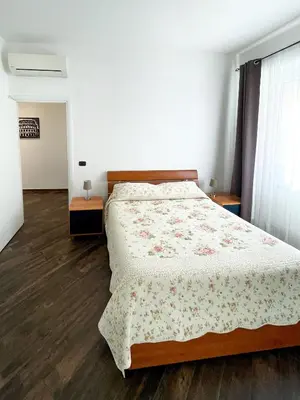 a bedroom with a bed with a floral bedspread at roominrome Alexander Apartment in Rome