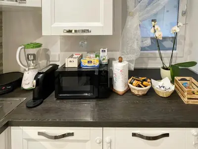 a kitchen counter with a black microwave on a counter top at roominrome Alexander Apartment in Rome