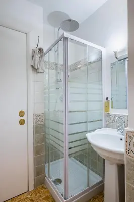 a bathroom with a glass shower and a sink at My Tiny Home Alchemy in Rome