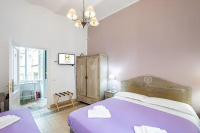 a bedroom with a purple bed and a chair at My Tiny Home Alchemy in Rome