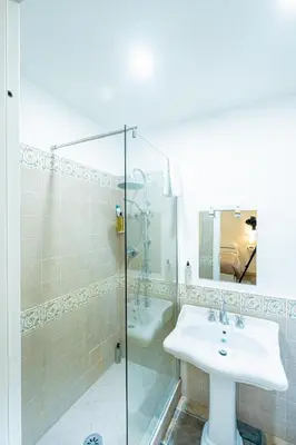 a bathroom with a sink and a glass shower at My Tiny Home Alchemy in Rome