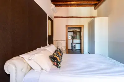 a bedroom with a white bed with white pillows at ROMAC Baullari II 4bdr near Campo de Fiori in Rome