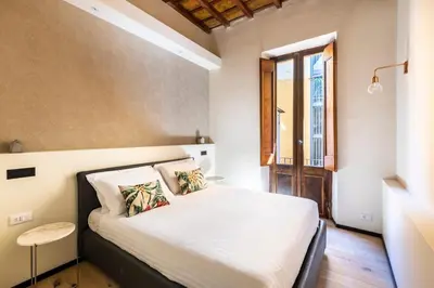 a bedroom with a white bed with a window at ROMAC Baullari II 4bdr near Campo de Fiori in Rome