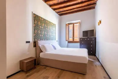 a bedroom with a bed and a television in it at ROMAC Baullari II 4bdr near Campo de Fiori in Rome