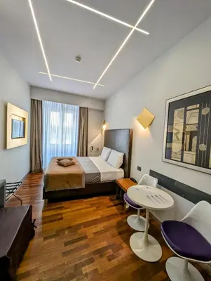 a hotel room with a bed and a table and chairs at Affittacamere RFI in Rome