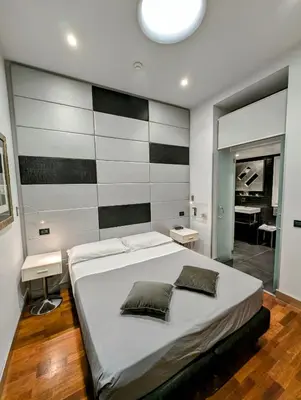 a bedroom with a large bed with two pillows on it at Affittacamere RFI in Rome
