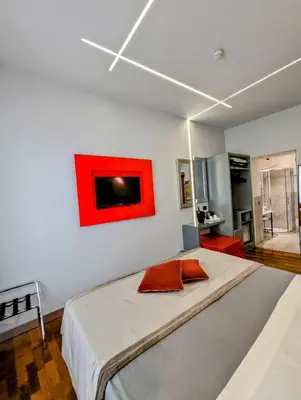 a bedroom with a large bed with a red painting on the wall at Affittacamere RFI in Rome
