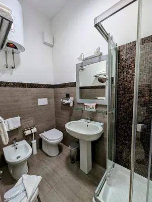 a bathroom with a sink and a toilet and a shower at Domus Forus in Rome