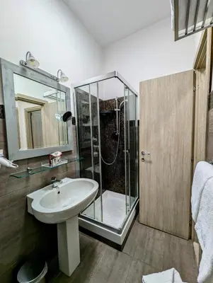 a bathroom with a sink and a glass shower at Domus Forus in Rome