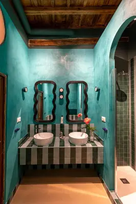 a bathroom with two sinks and a blue wall at ROMAC Baullari III - Family apartment in Campo de Fiori in Rome