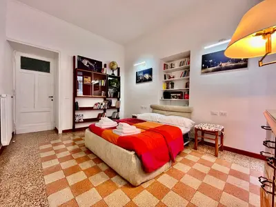 a bedroom with a bed and a book shelf at Atelier Montecuccoli in Rome