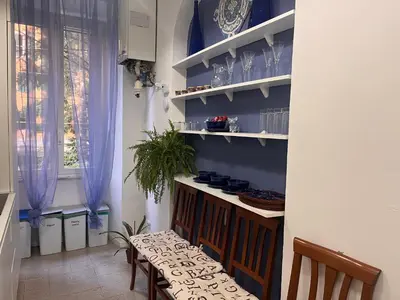 a kitchen with blue walls and a table and chairs at Atelier Montecuccoli in Rome