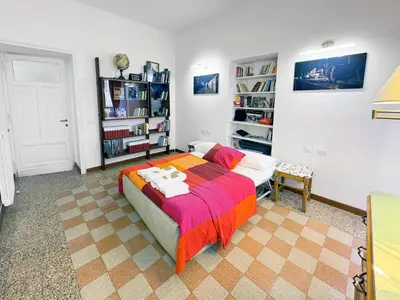 a bedroom with a bed and a book shelf at Atelier Montecuccoli in Rome