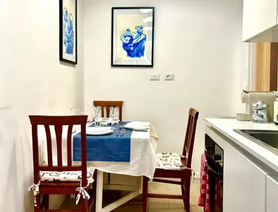 a kitchen with a table and chairs and a sink at Atelier Montecuccoli in Rome