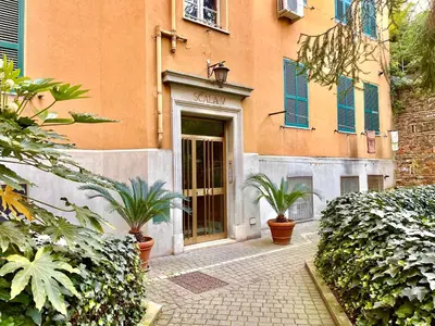 a door to a building with two plants in front of it at Atelier Montecuccoli in Rome