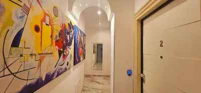 a hallway with a large painting on the wall at Il Magnifico Superior Rooms 400m from Tiburtina Railway Station and 290m from Metro in Rome