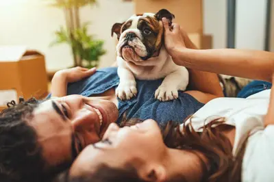 a person laying on a bed with a dog at Il Magnifico Superior Rooms 400m from Tiburtina Railway Station and 290m from Metro in Rome
