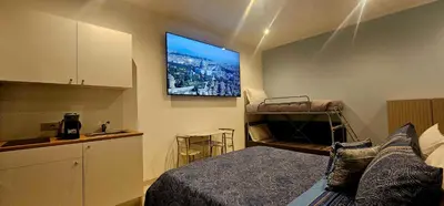 a bedroom with a bed and a tv on the wall at Il Magnifico Superior Rooms 400m from Tiburtina Railway Station and 290m from Metro in Rome