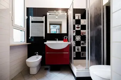 a bathroom with a red sink and a toilet at Appartamento vista Colosseo in Rome