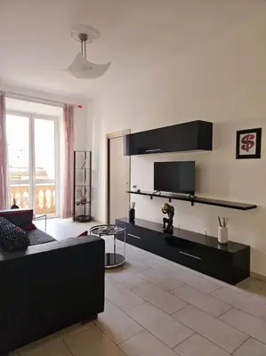 a living room with a couch and a tv at Appartamento vista Colosseo in Rome