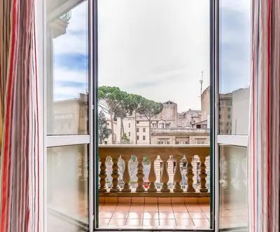 an open window with a view of a city at Appartamento vista Colosseo in Rome